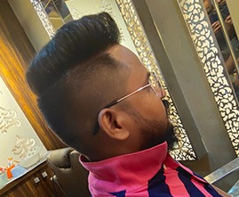 Stylist giving haircut to a male customer