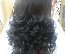 Stylist giving haircut to a male customer